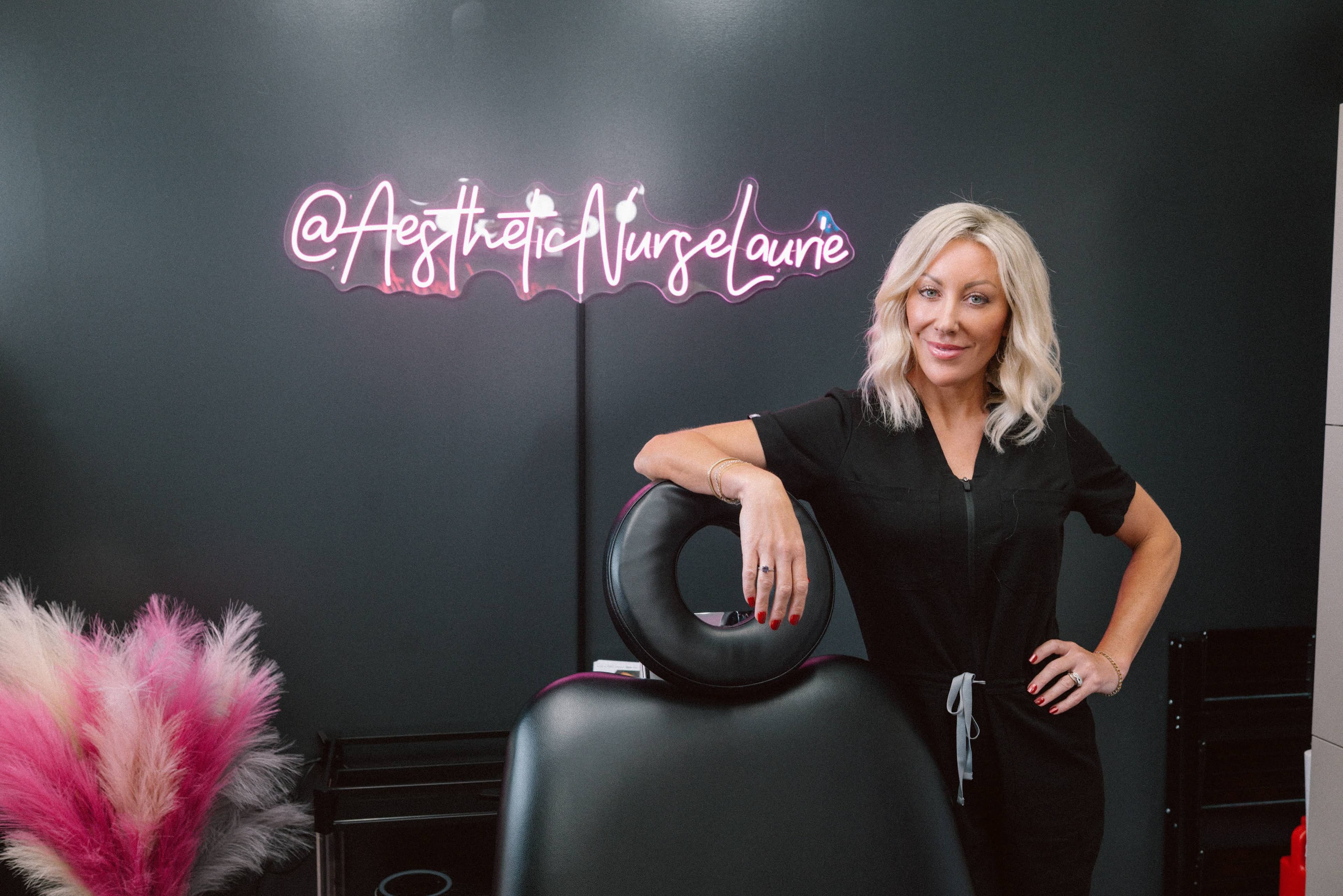Nurse Injector in her office with neon sign