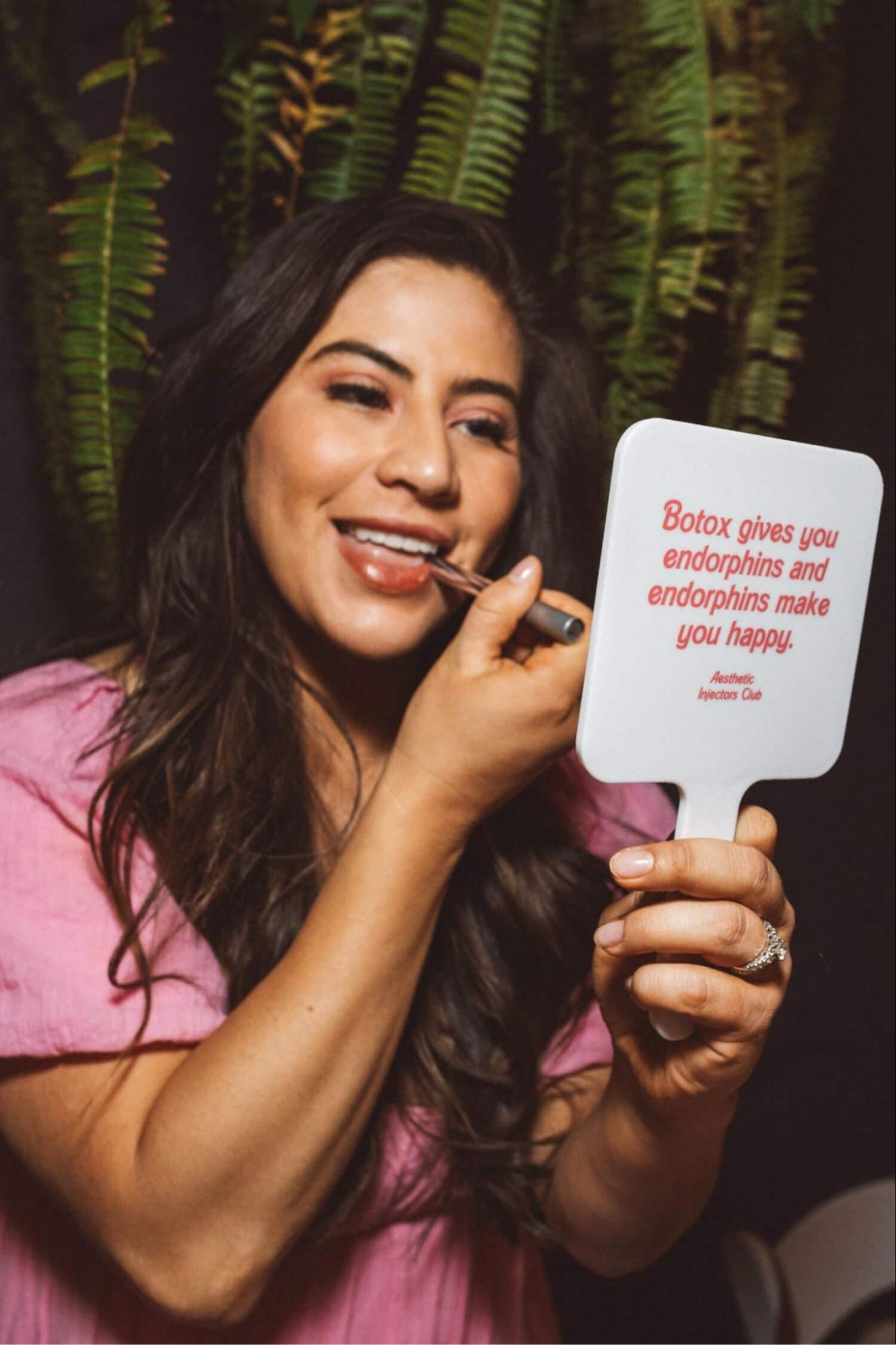 aesthetic injectors club mirror putting on lipstick